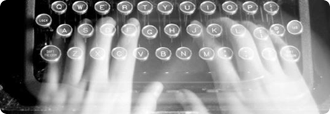 Hands typing on a vintage typewriter